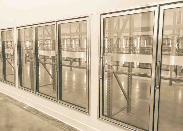 Vintage tone empty and recently remodeled large commercial fridges at whole store in America. Sold out frozen food section
