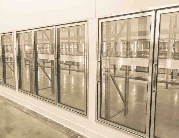 Vintage tone empty and recently remodeled large commercial fridges at whole store in America. Sold out frozen food section