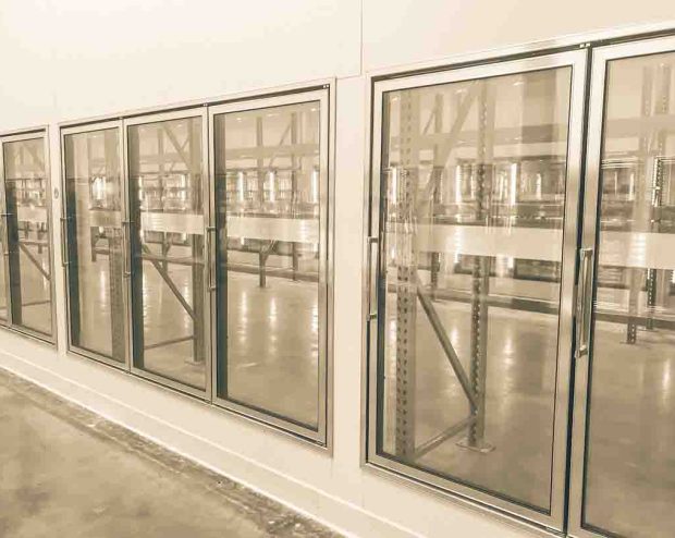 Vintage tone empty and recently remodeled large commercial fridges at whole store in America. Sold out frozen food section